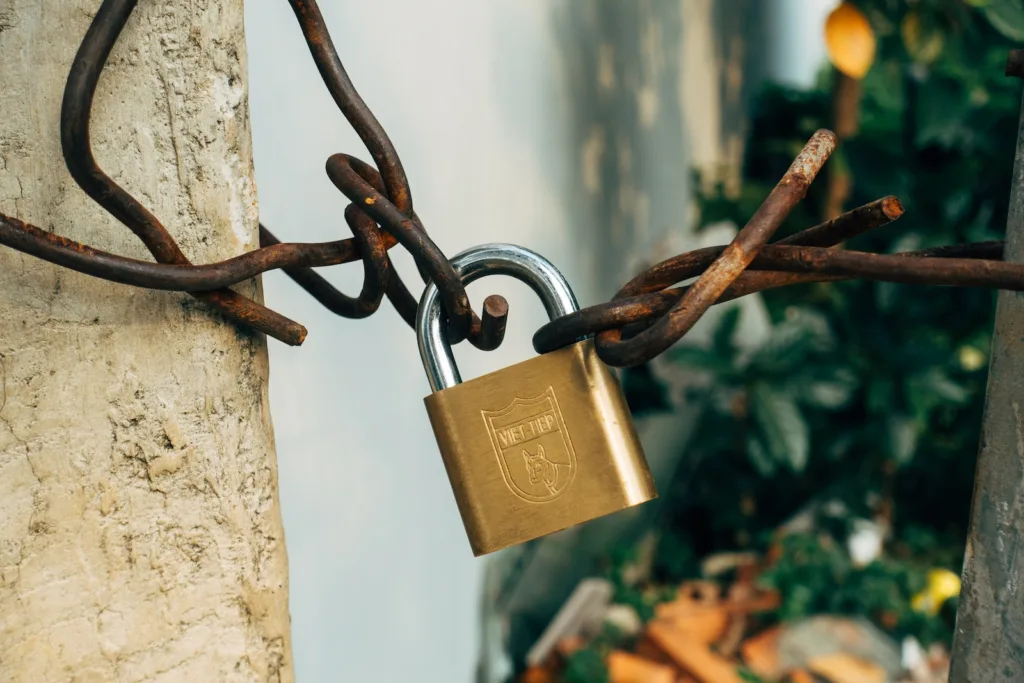 unlock potential, brass padlock on brown metal fence