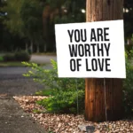 you are worthy of love sign beside tree and road backyard studio shed